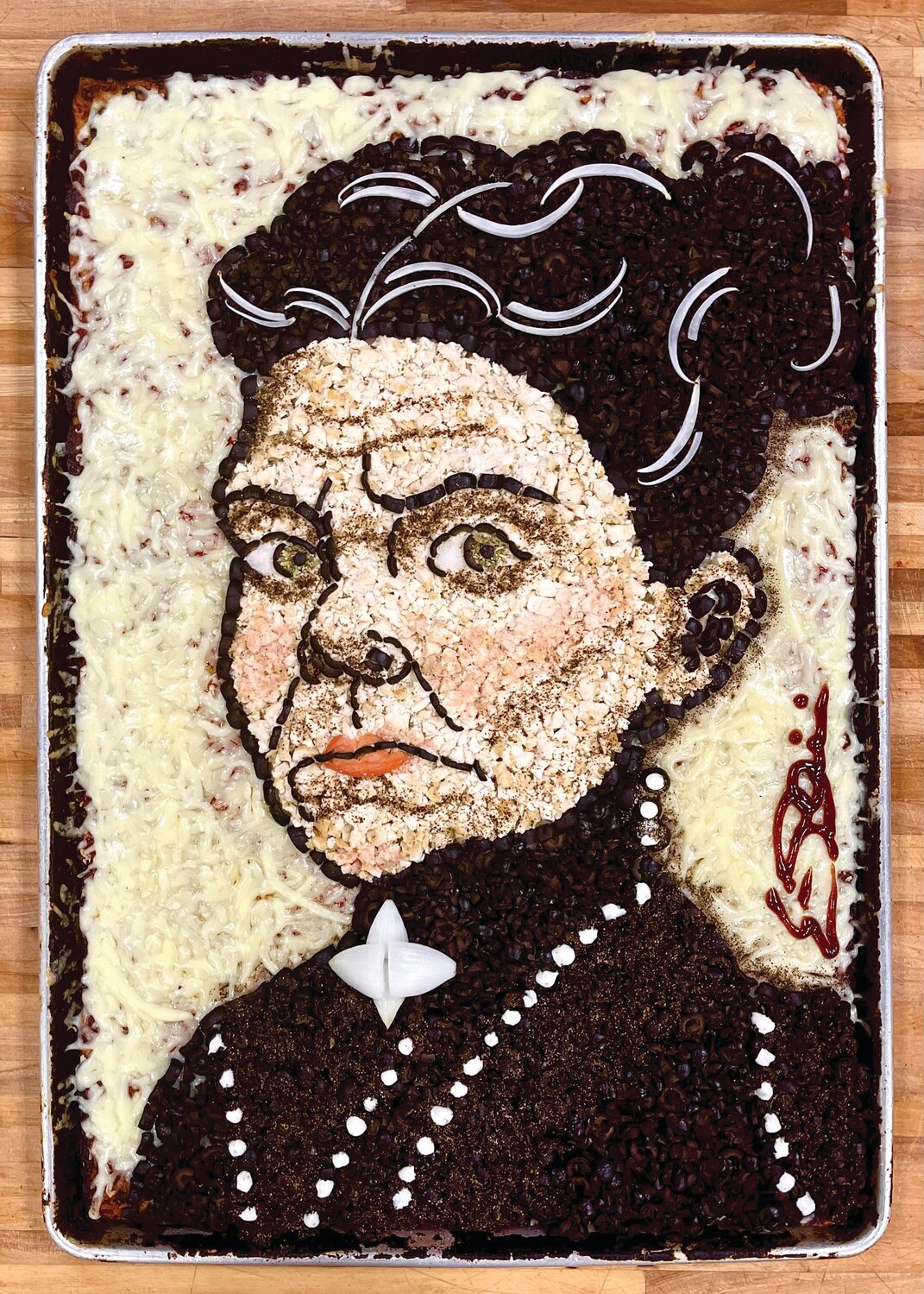 PIZZA ART: Eric Palmieri crafts portraits with pizza. He’s tackled an array of subjects from action star Sylvester Stallon to late Fall River murderess Lizzie Borden, to pizza reviewer and Barstool Sports magnate Dave Portnoy. (Submitted photo)